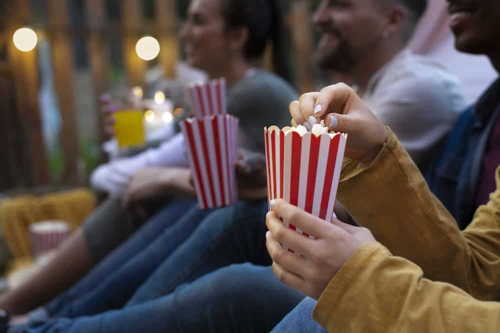 young-friends-having-fun-cinema-open-air
